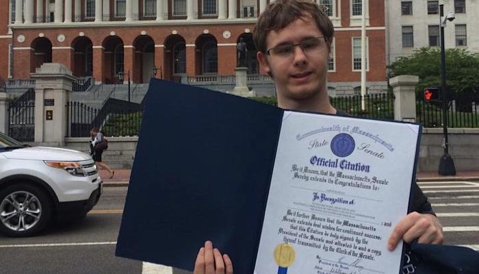 Aaron with a certificate
