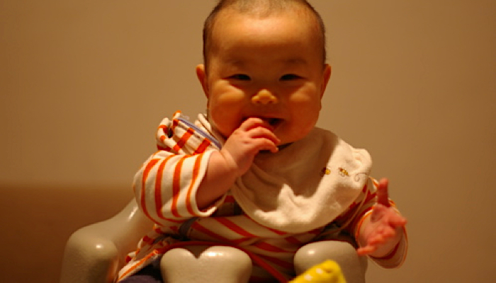 A baby in a bumbo seat