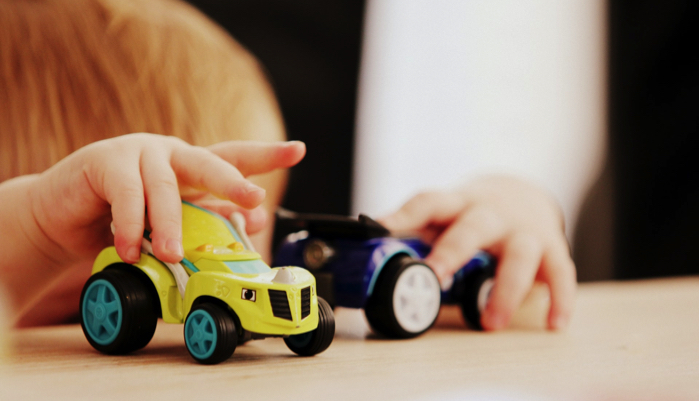 boy playing with toy cars