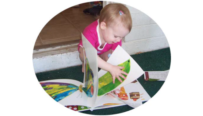 little girl exploring a picture book