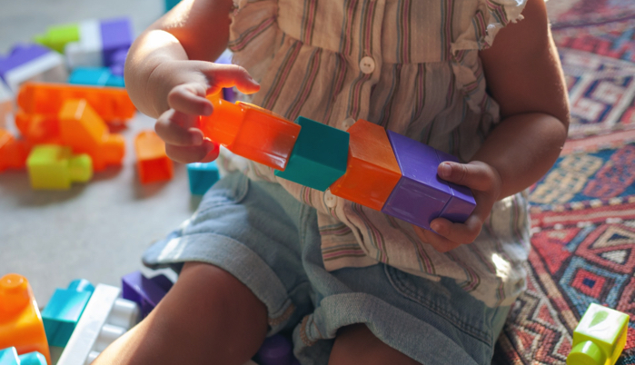 little girl playing with a toy