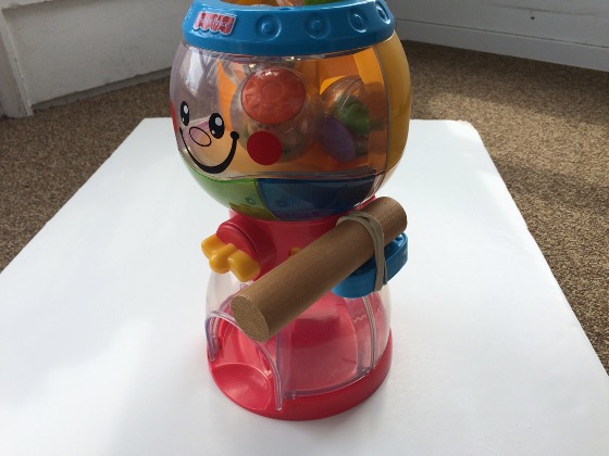 wooden block added to a gumboil toy