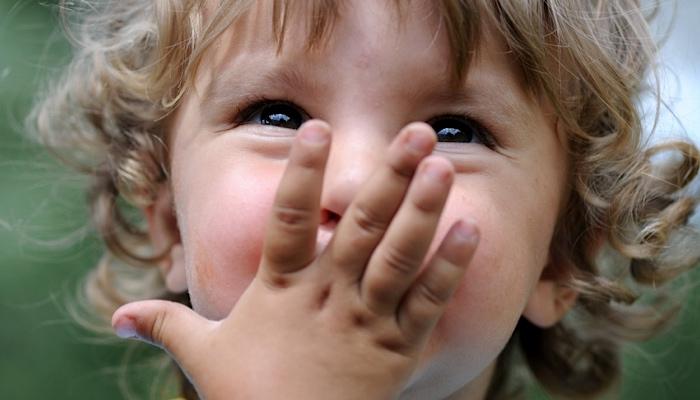 boy kissing his hand