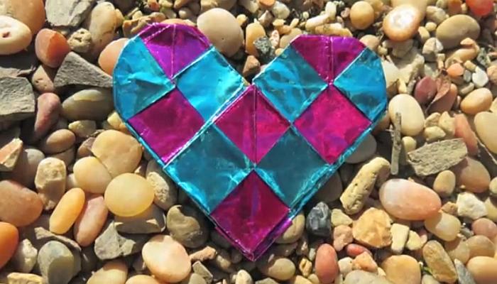 paper heart on background of pebbles