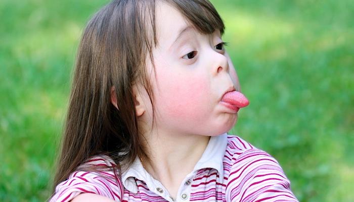 little girl sticking out her tongue