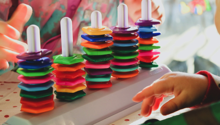 two young children playing with a toy