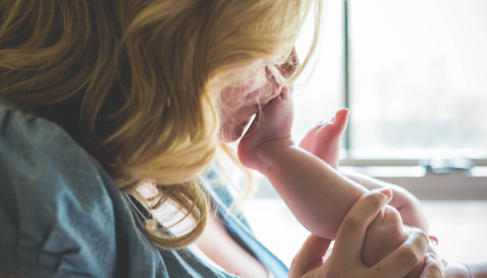 Mother kissing her baby's foot