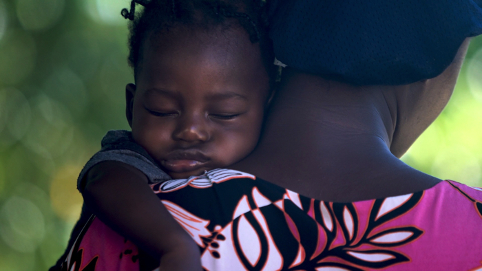 Mother rocking baby to sleep