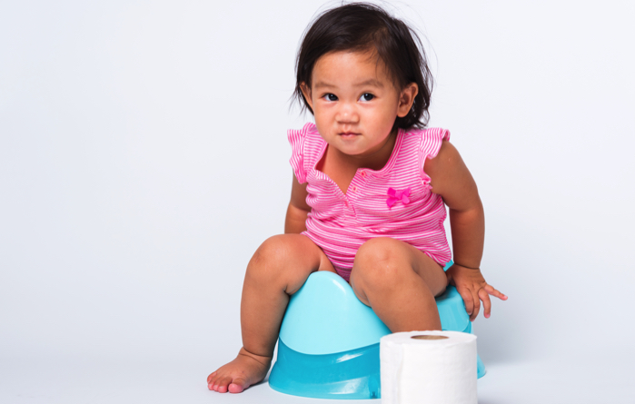 little girl sitting on a potty