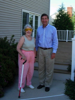 Ed standing in front of the house with his mom, Jane