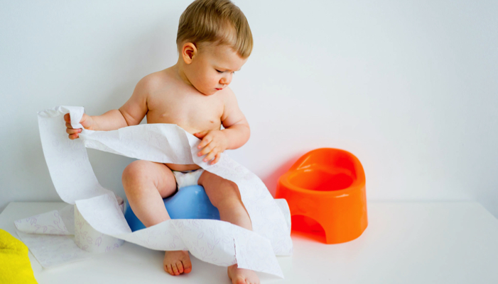 toddler boy sitting on a potty