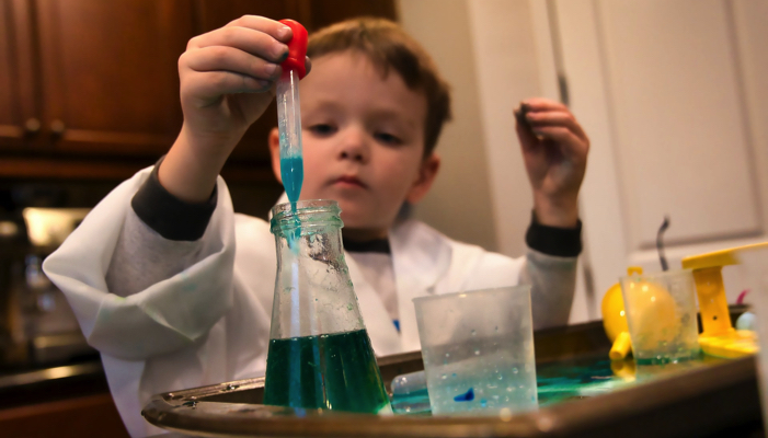 a young boy doing chemistry