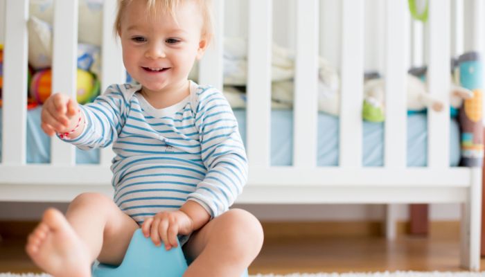 Smiling boy potty training.