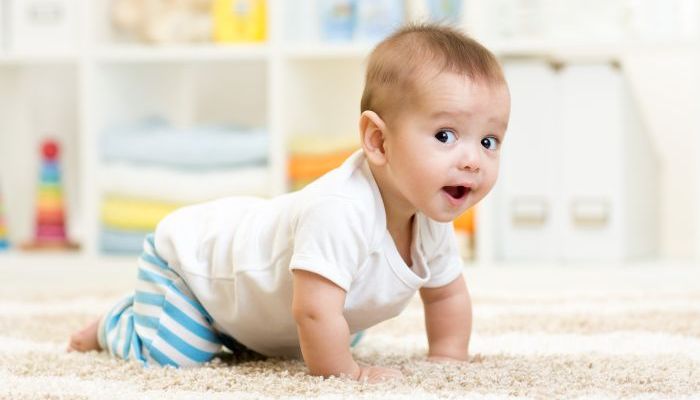 Baby crawling on carpet.