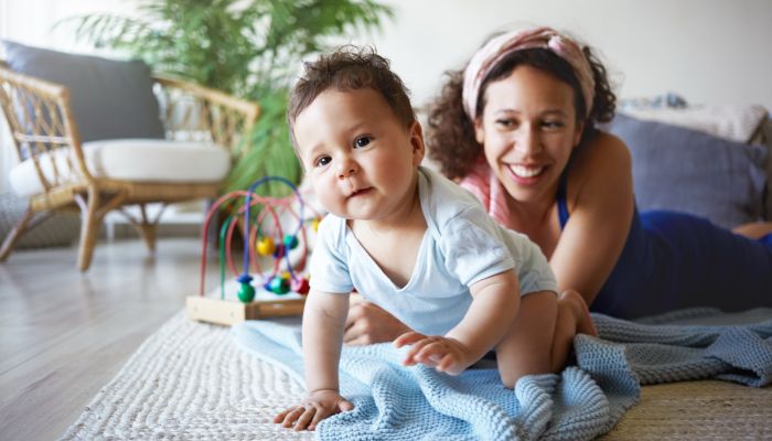 Baby crawling with mom.