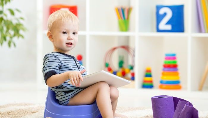 Baby on potty with iPad.