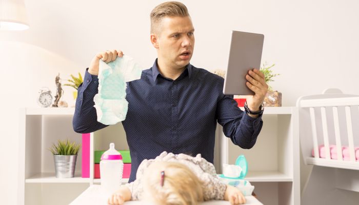 Confused dad changing diaper.