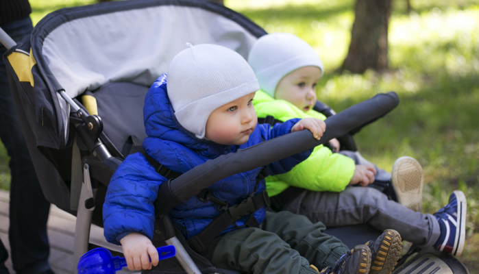 twin baby boys in a double stroller