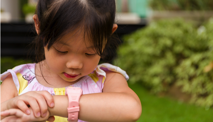 young girl with a potty watch