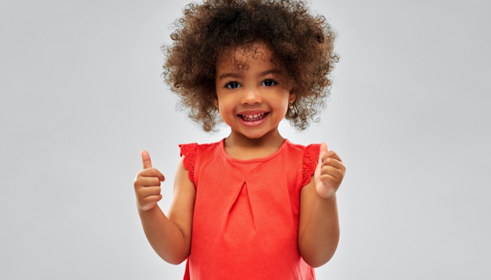 little girl with thumbs up