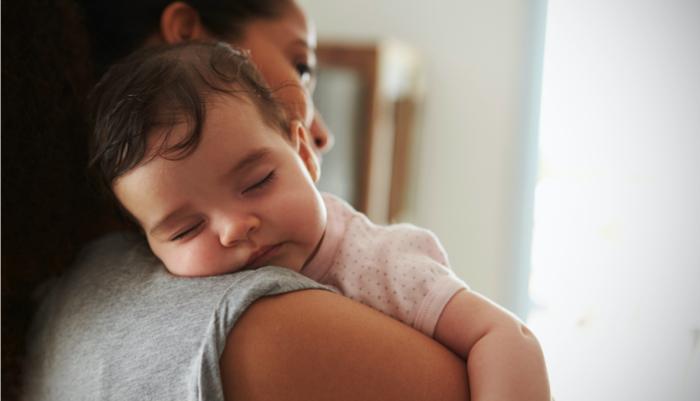 mom holding a sleeping baby