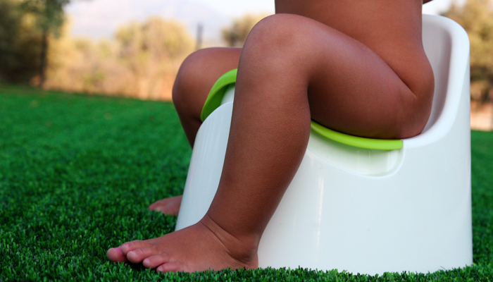 Baby sitting on potty chair.