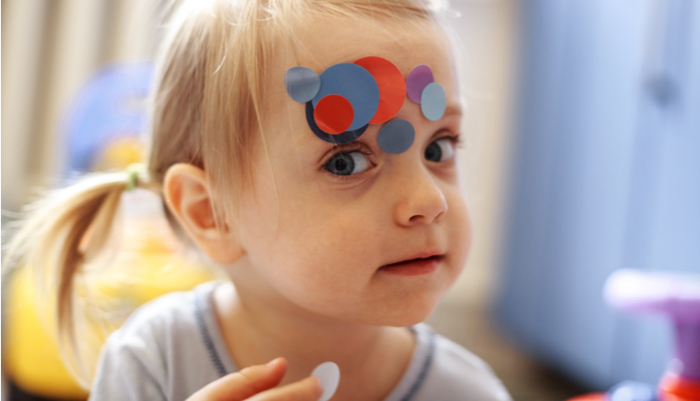 a little girl playing with stickers