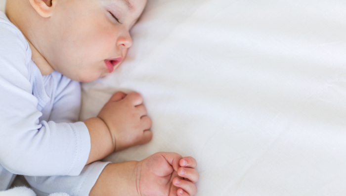 baby asleep on a sheet