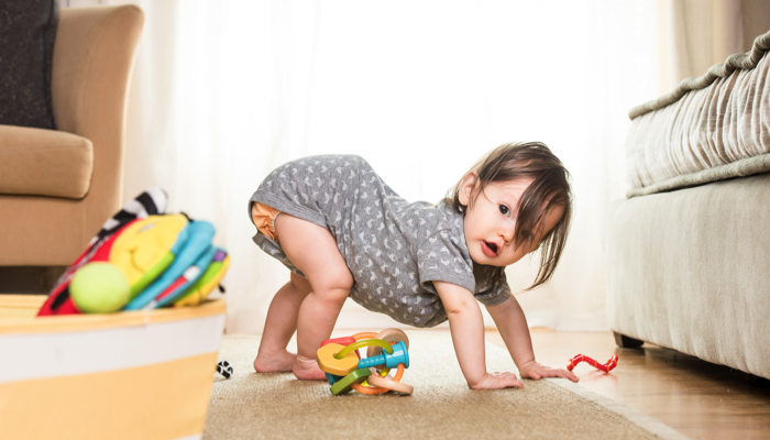 Little girl doing a bear crawl.