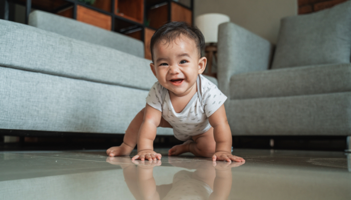 Baby crawling with one leg out.