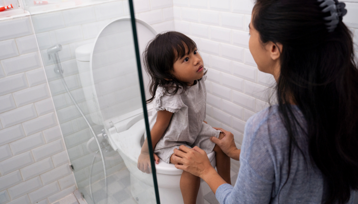 girl sitting on potty