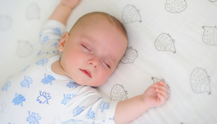 baby asleep on a mattress