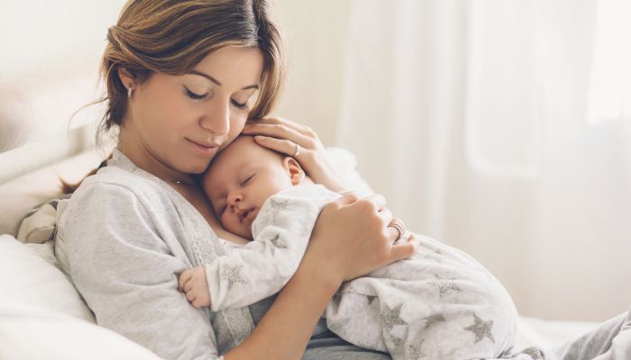 Baby sleeping on mom.