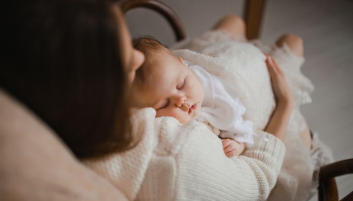 Baby sleeping while held.