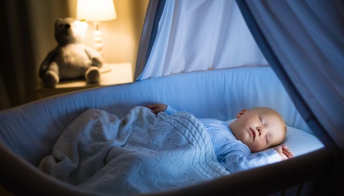 Baby sleeping in bassinet.