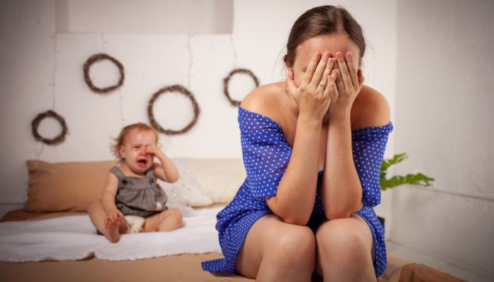 Tired mom with crying baby.