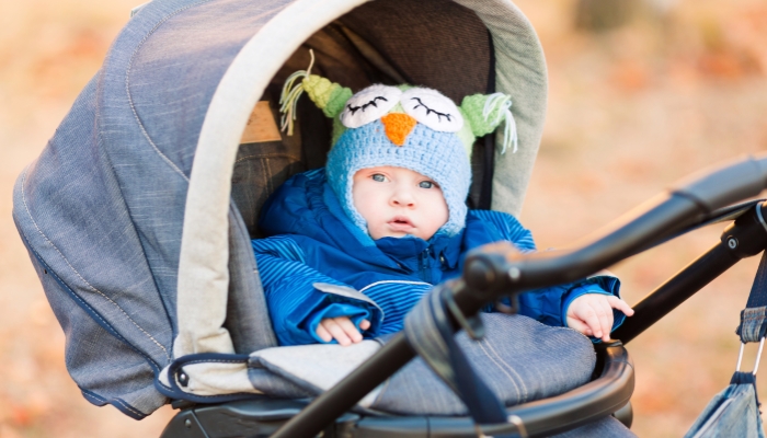 Cute little baby in a stroller outdoor.