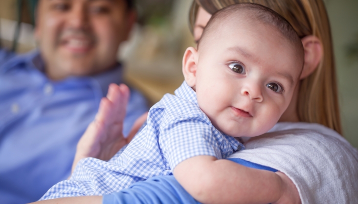 Couple burping their son.