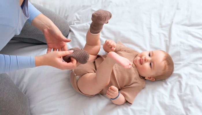 Mom fixing her baby's socks.