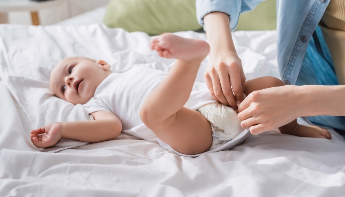 Mother changing baby diapers