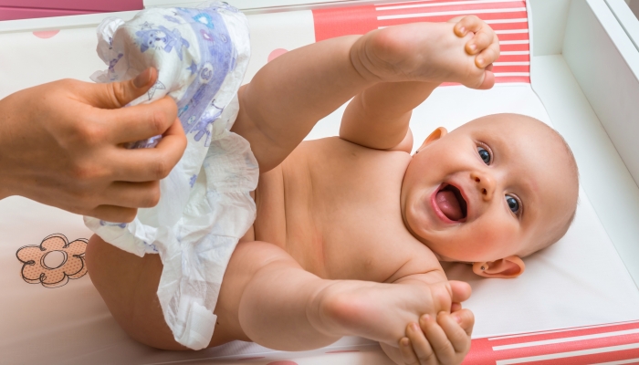 Mother changing baby's diaper.