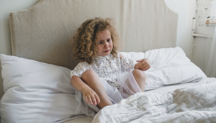 Toddler throws tantrums in bed.