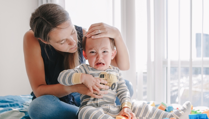 Mother pacifying her toddler.