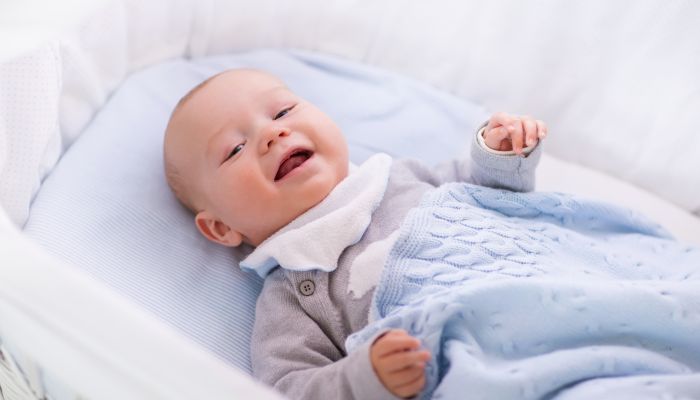 Baby in rocking bassinet.