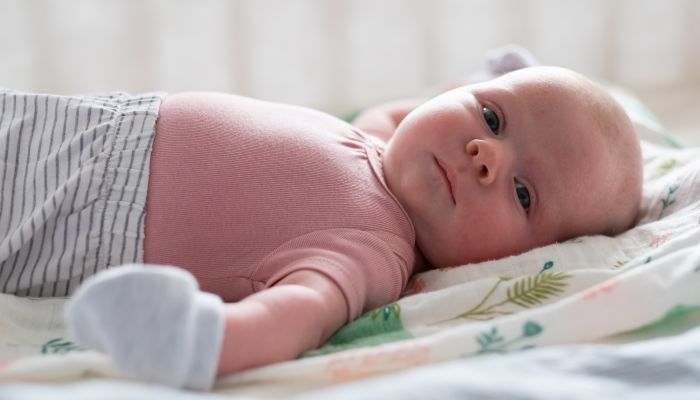 Baby wearing sleep mittens.