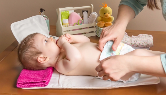 Mom changing her baby's diaper.