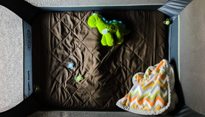 Pack-n-play crib with toys.