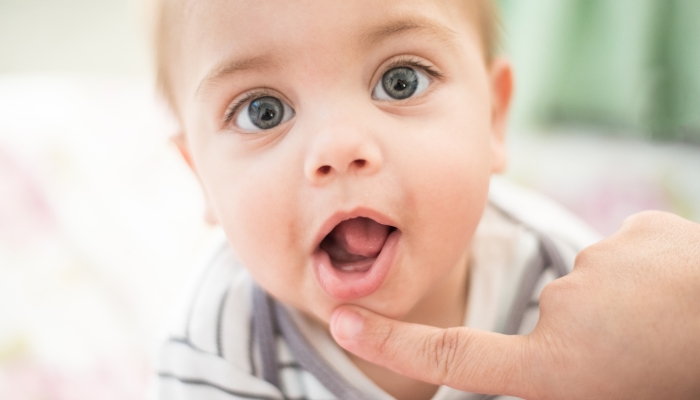 Baby smiling - Baby tooth - Mom's hand