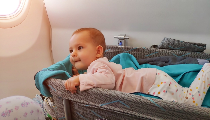 Happy infant baby in a bassinet.