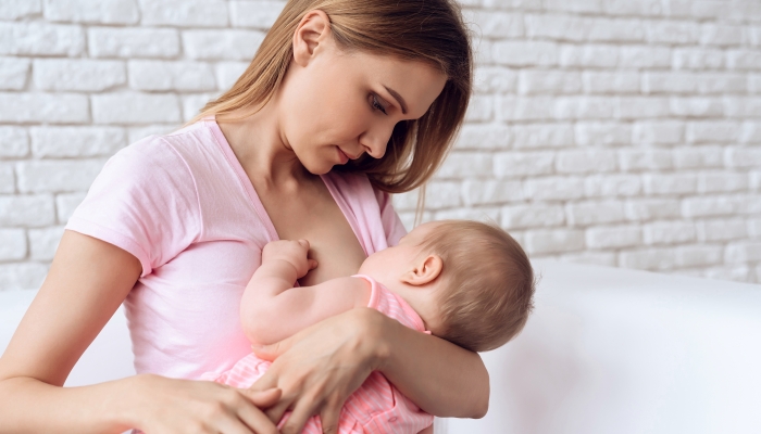 Young mother feeding her baby.